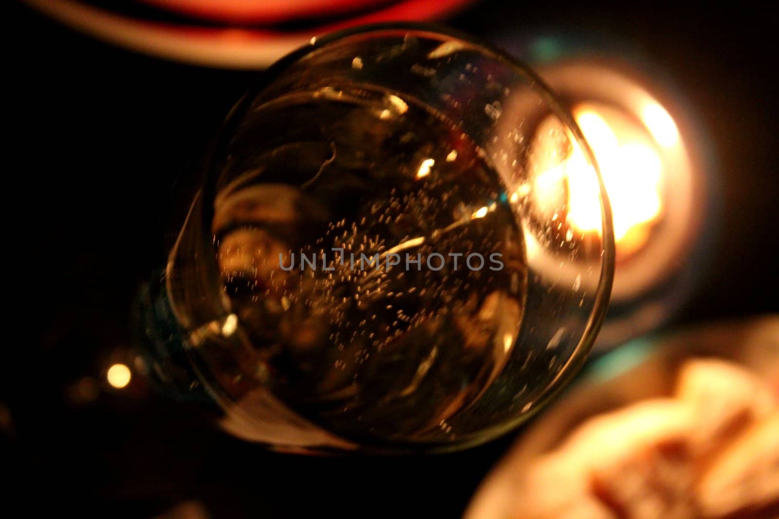 bubbly glass of champagne by candlelight, food still life