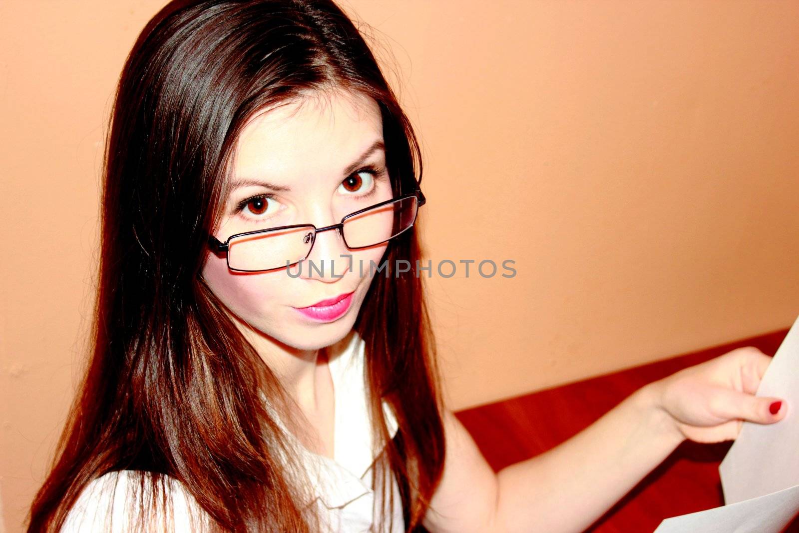 Portrait of a business women with glasses reading the document