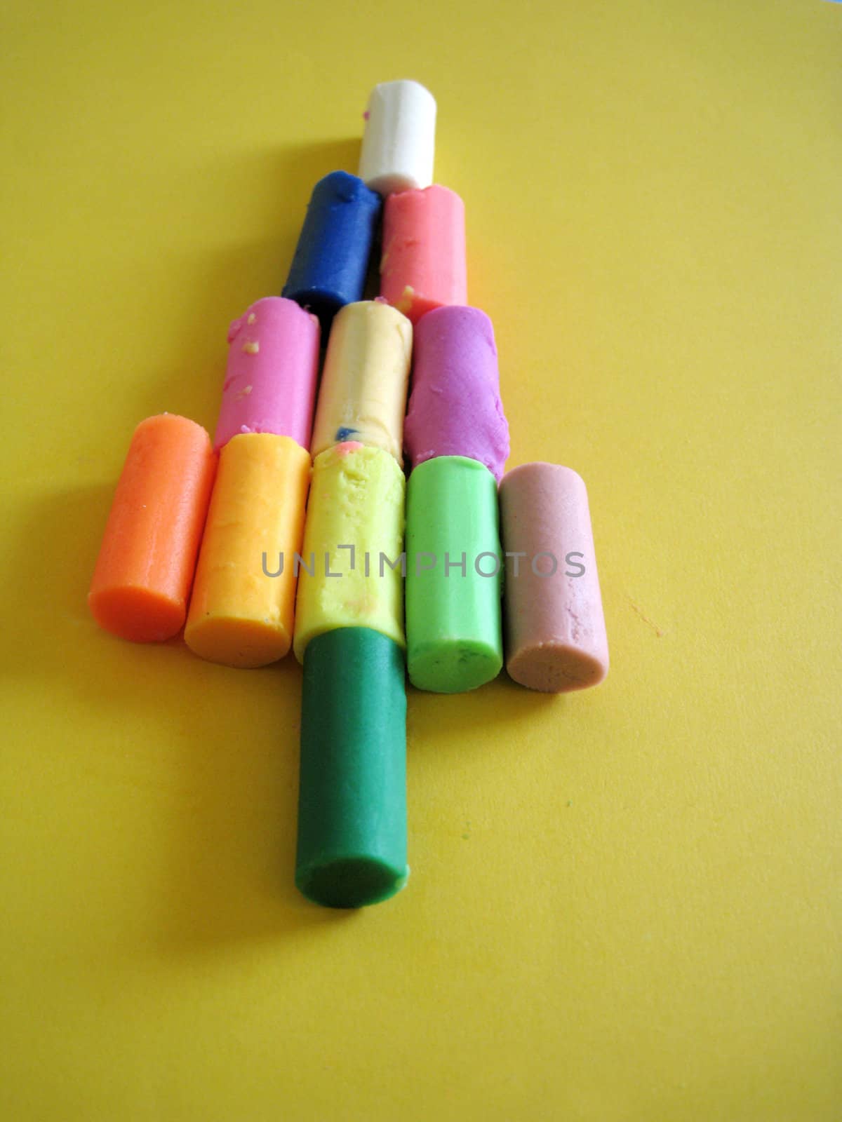 a christmas tree shape made by multi color crayon