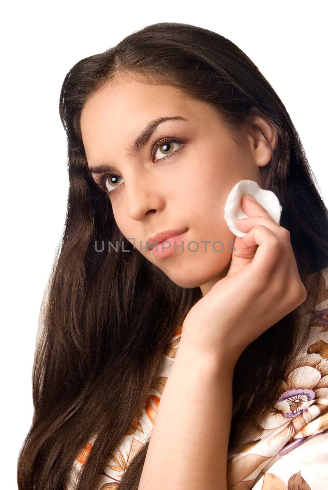 Young sexy model with green eyes removing cosmetics by cotton pads