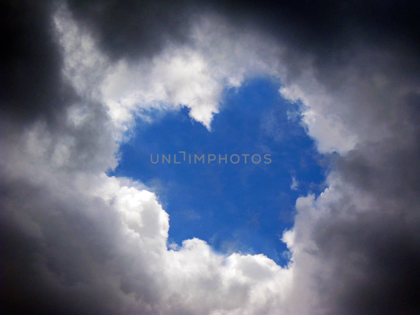 blue love shape sky around with heavy clouds