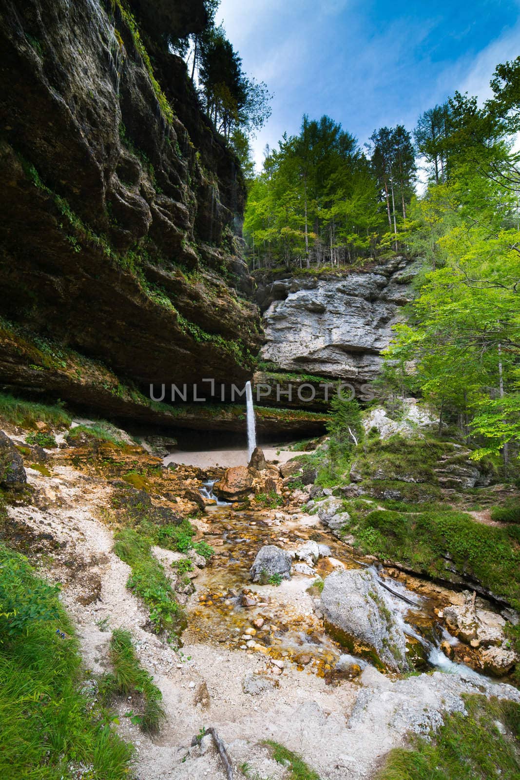 Small waterfall in Julian Alps in Slovenia - ultra wide photo