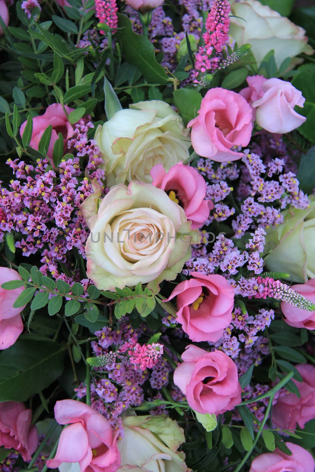 Mixed floral arrangement in different shades of pink and purple by studioportosabbia