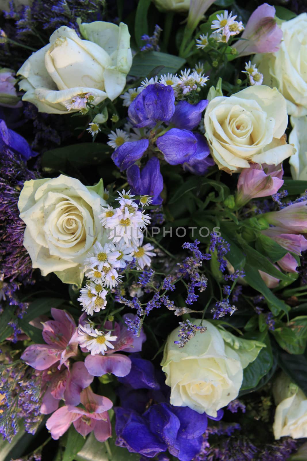 Blue and white flower arrangement with iiris and white roses