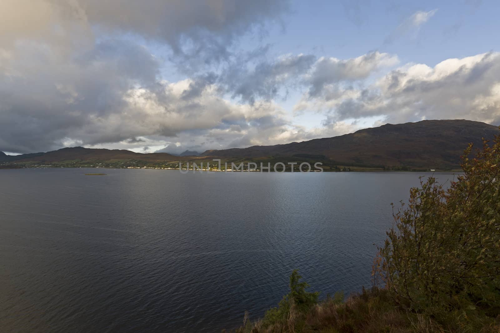 lake in the highlands with clouds and mountains