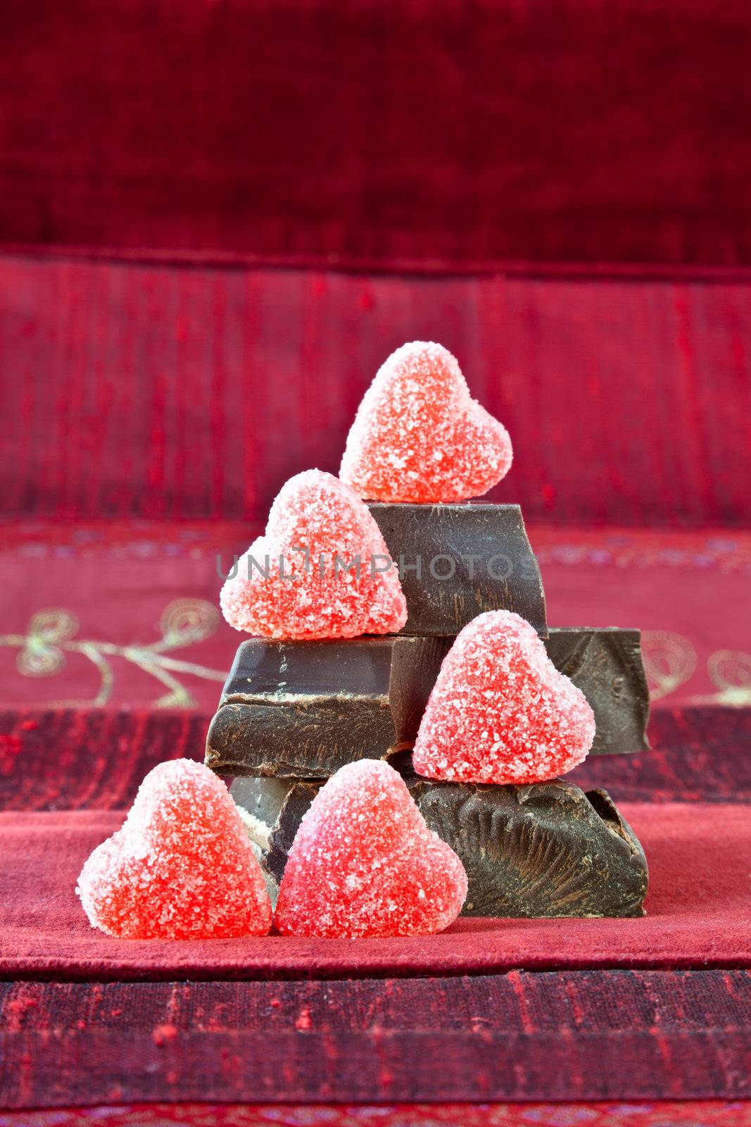 Candy Hearts on a Pile of Dark Chocolate Pieces by DashaRosato