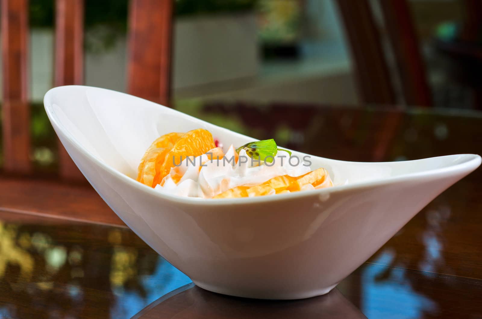Ice cream dessert with kiwi, strawberry and orange