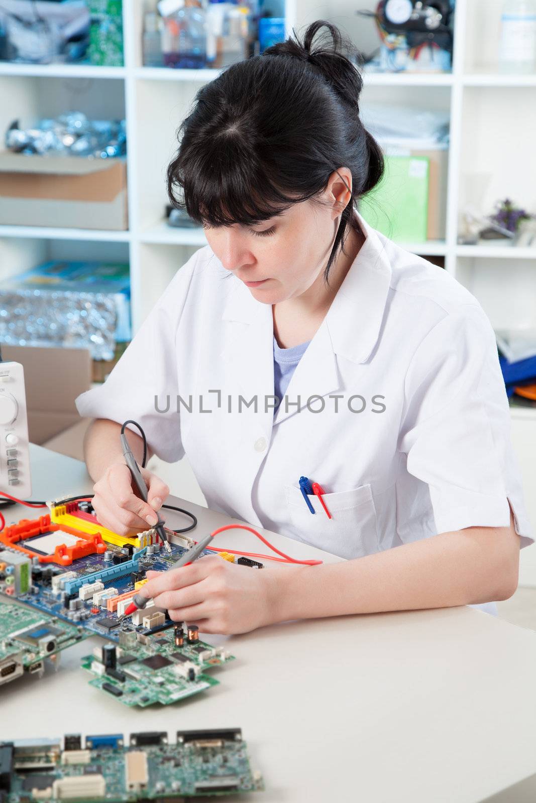 Girl debugging an electronic precision device by motorolka