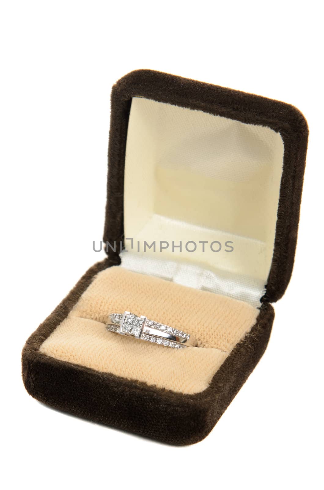 A diamond ring in a box, isolated against a white background