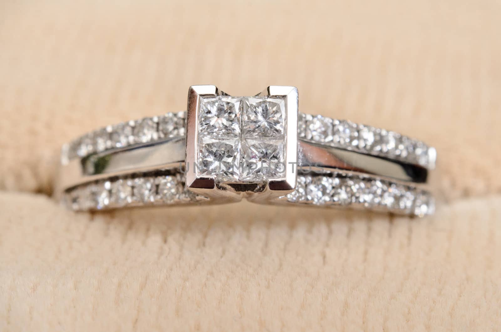 A closeup view of a diamond engagement ring, while sitting in the box.