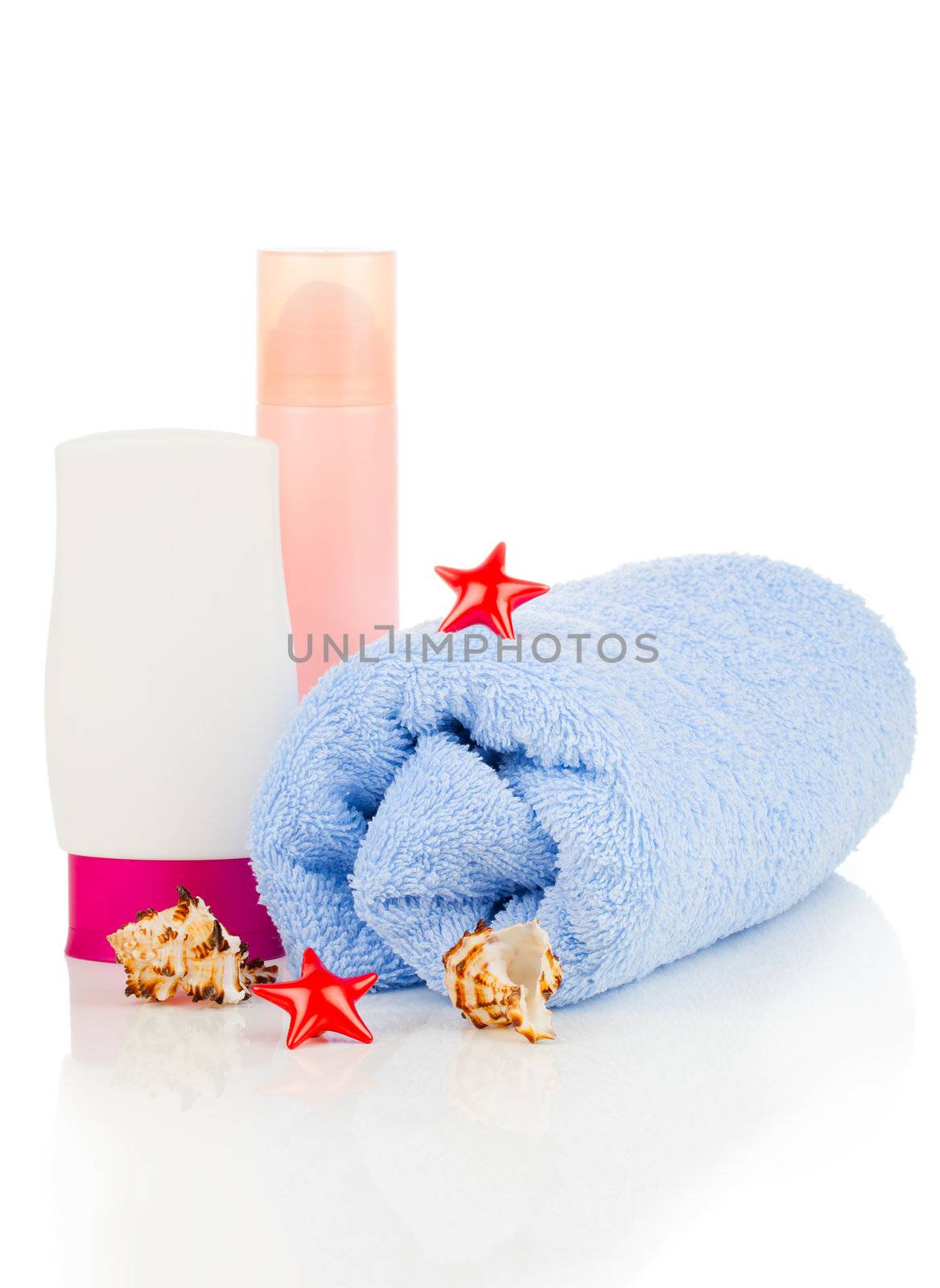 sunscreen cream and bath towel isolated on white by motorolka