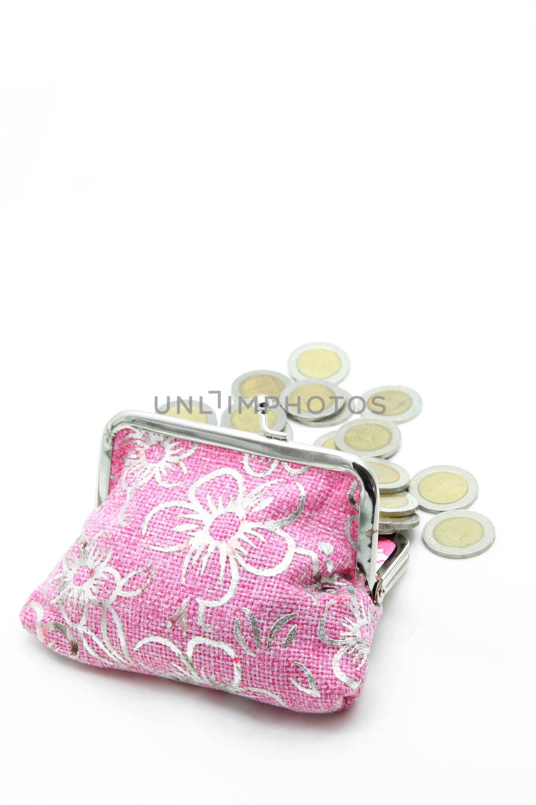 coins spilling out from flower pink money bag or purse isolated on white