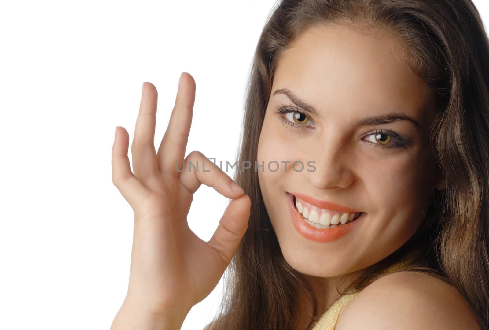 Beautiful smiling model with OK gesture with well-conditioned skin and teeth