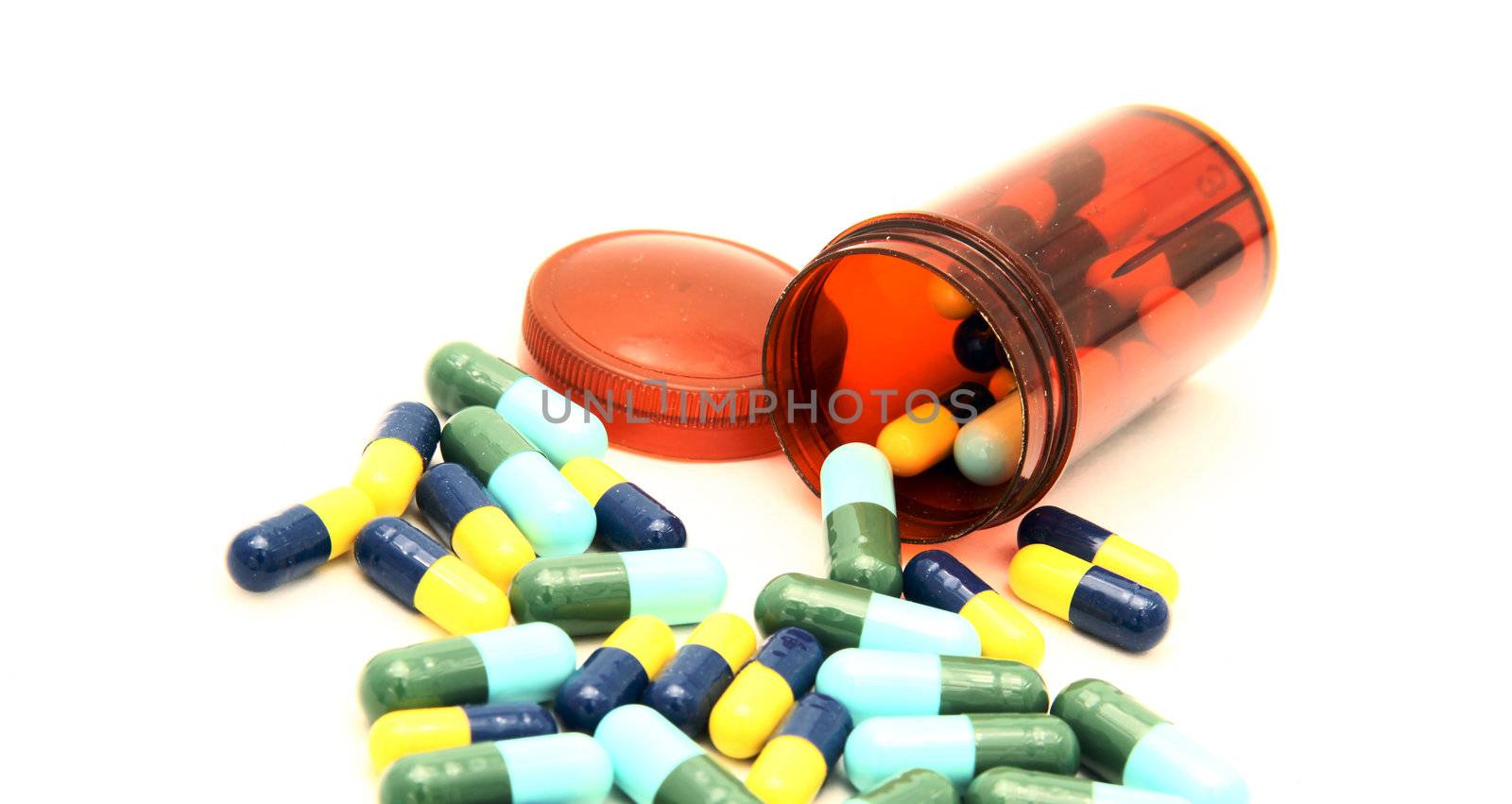 colorful capsule spilling out from pill box