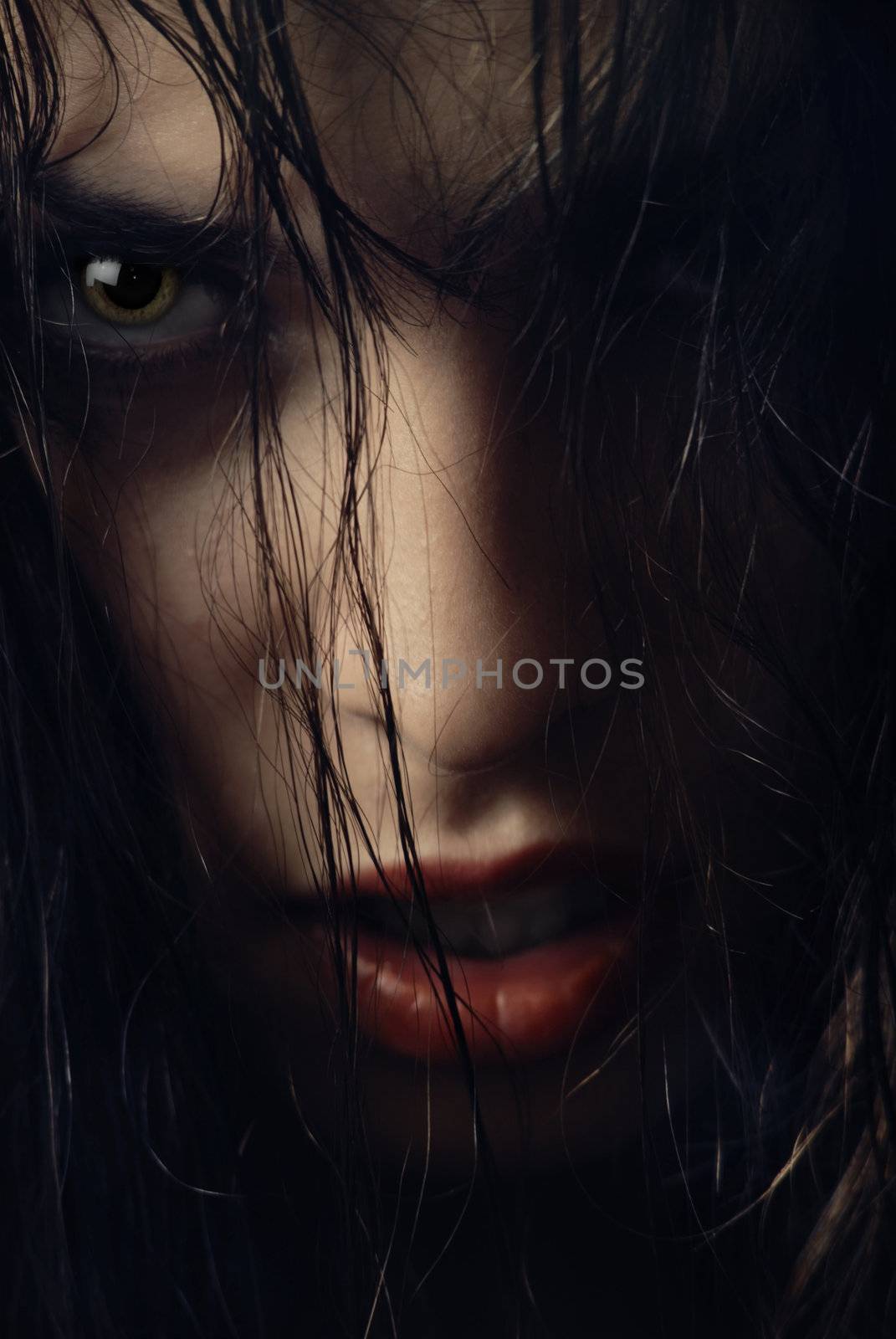 Close-up portrait of woman-witch with wet hairs