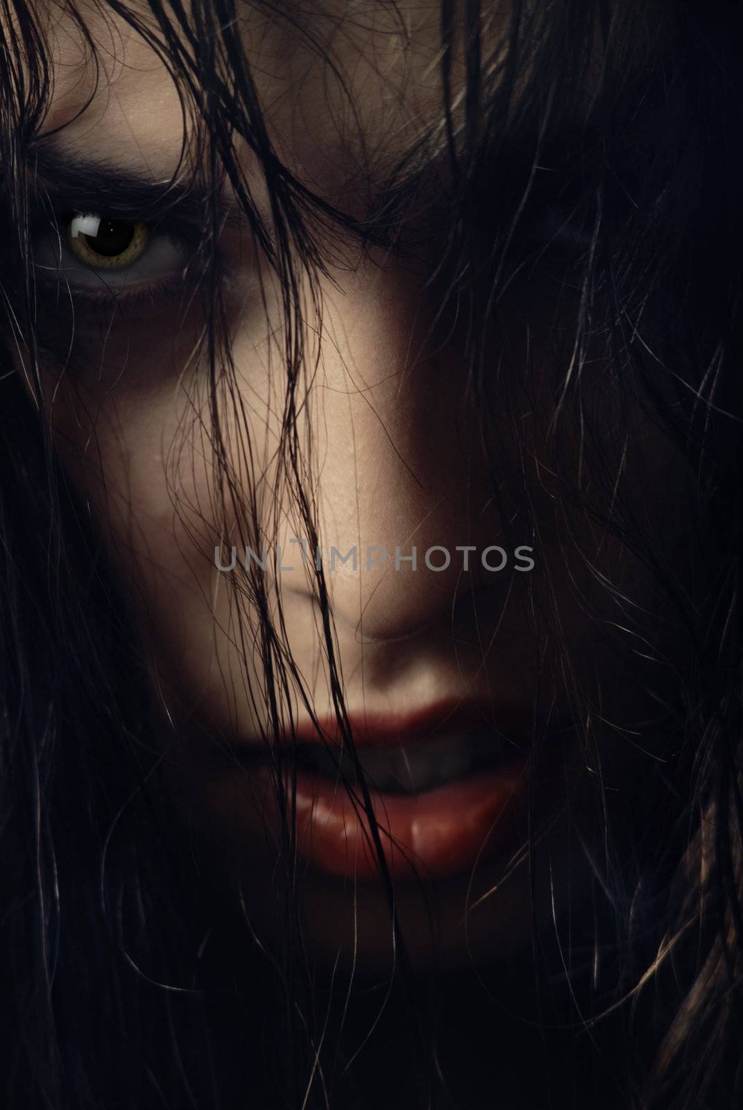 Close-up portrait of woman-witch with wet hairs