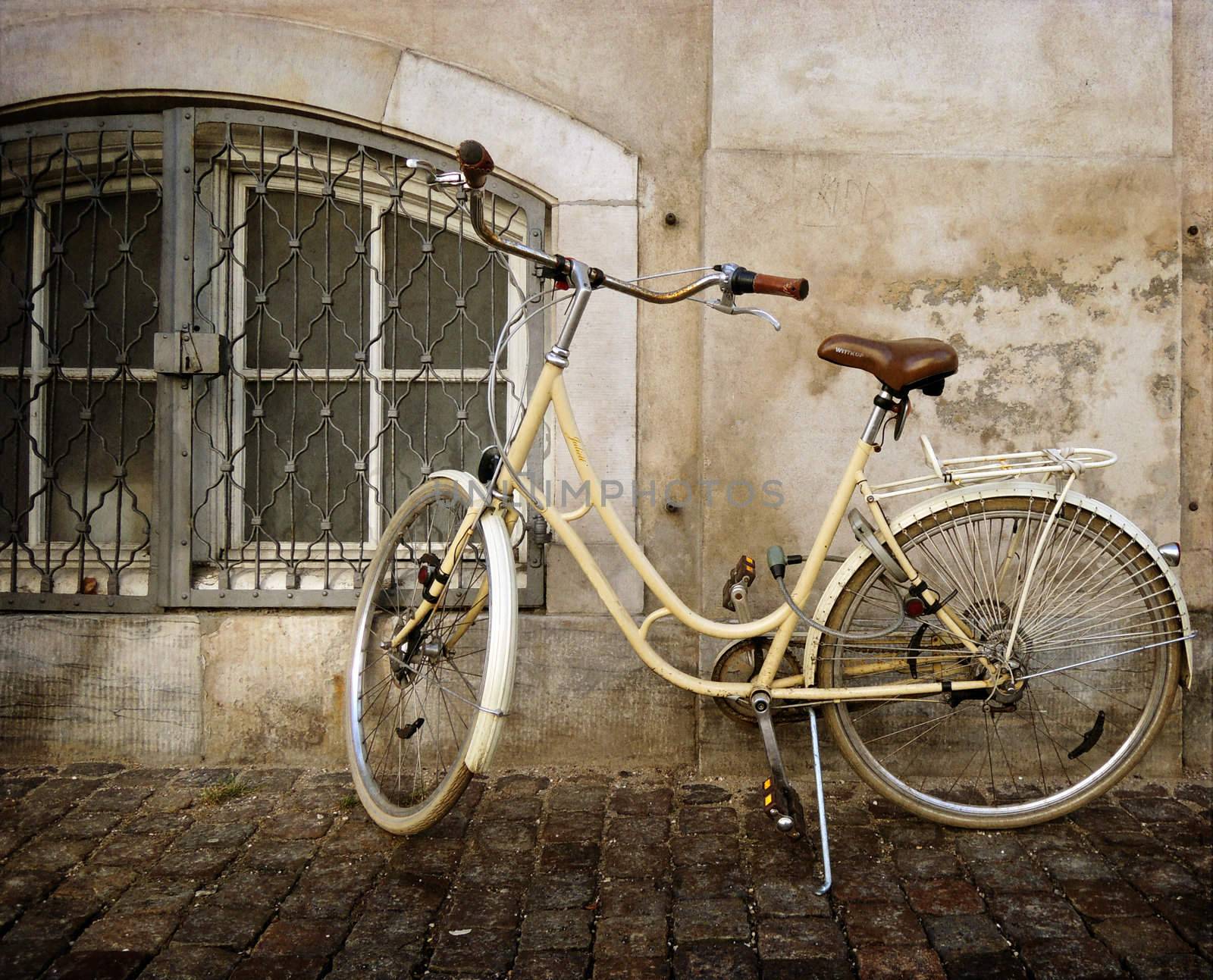 old style rusty bicycle and wall