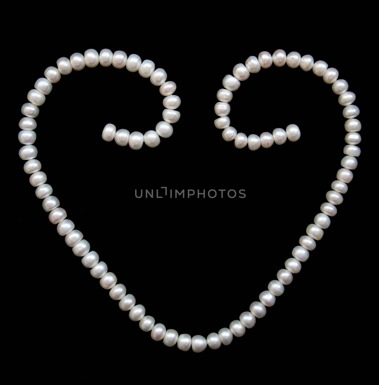 White pearls on the black silk can use as background 