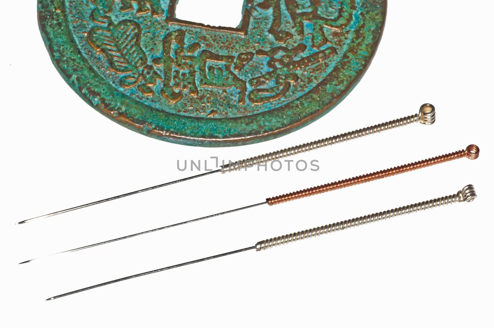 acupuncture needles on chinese coin by Jochen