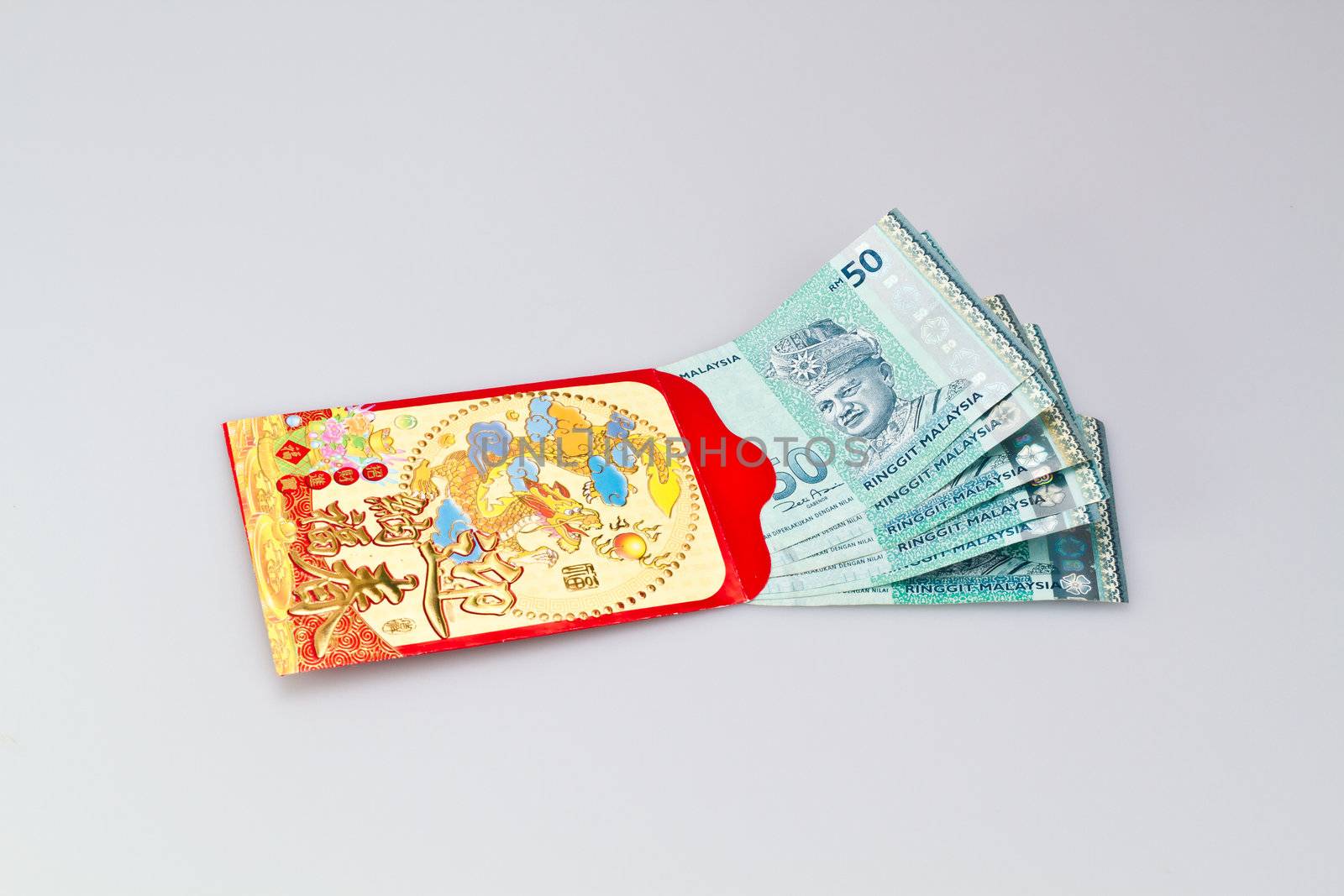 Malaysian Ringgit Banknote halfway in red packet Angpau for chinese new year celebration