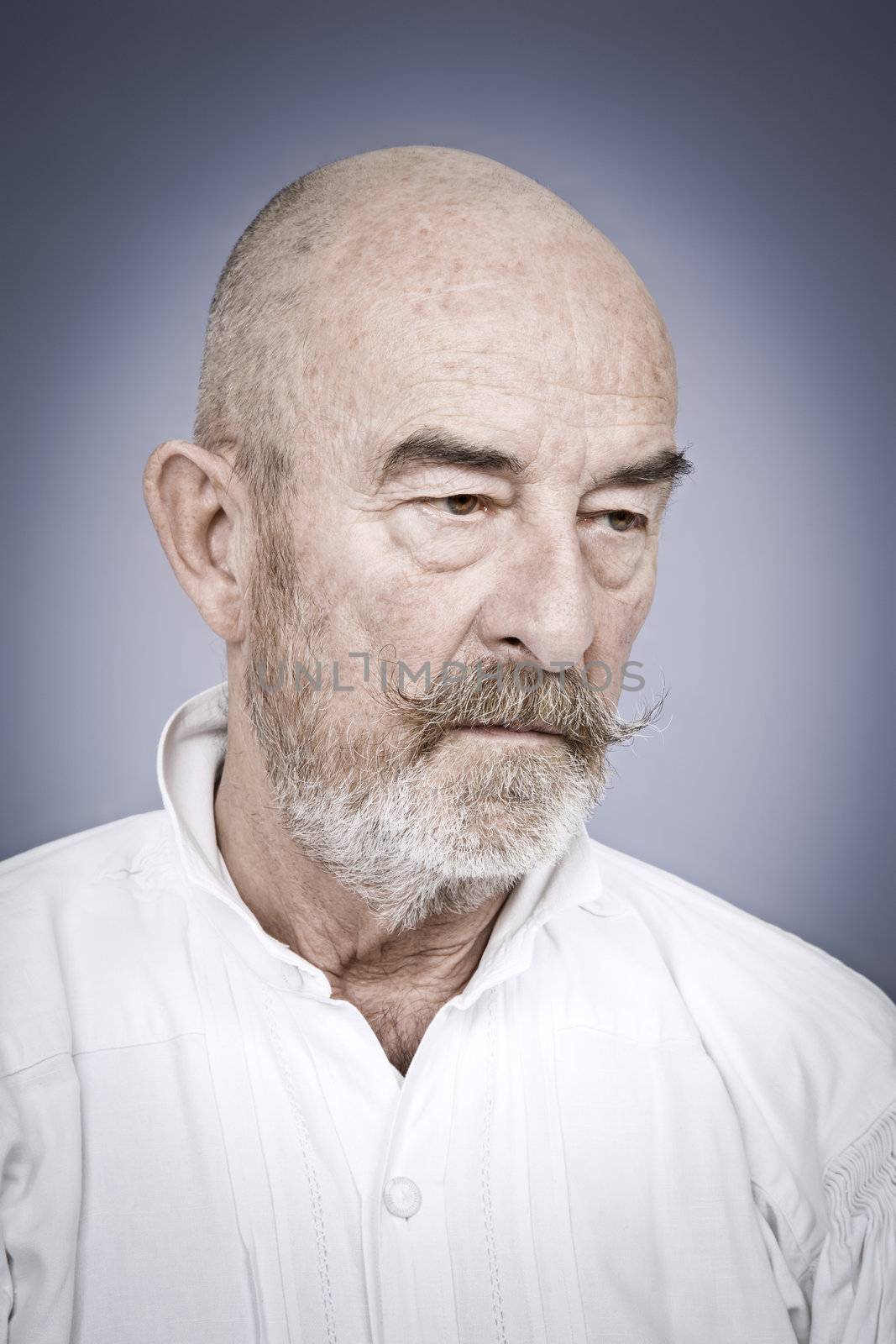 An old man with a grey beard is hopeless