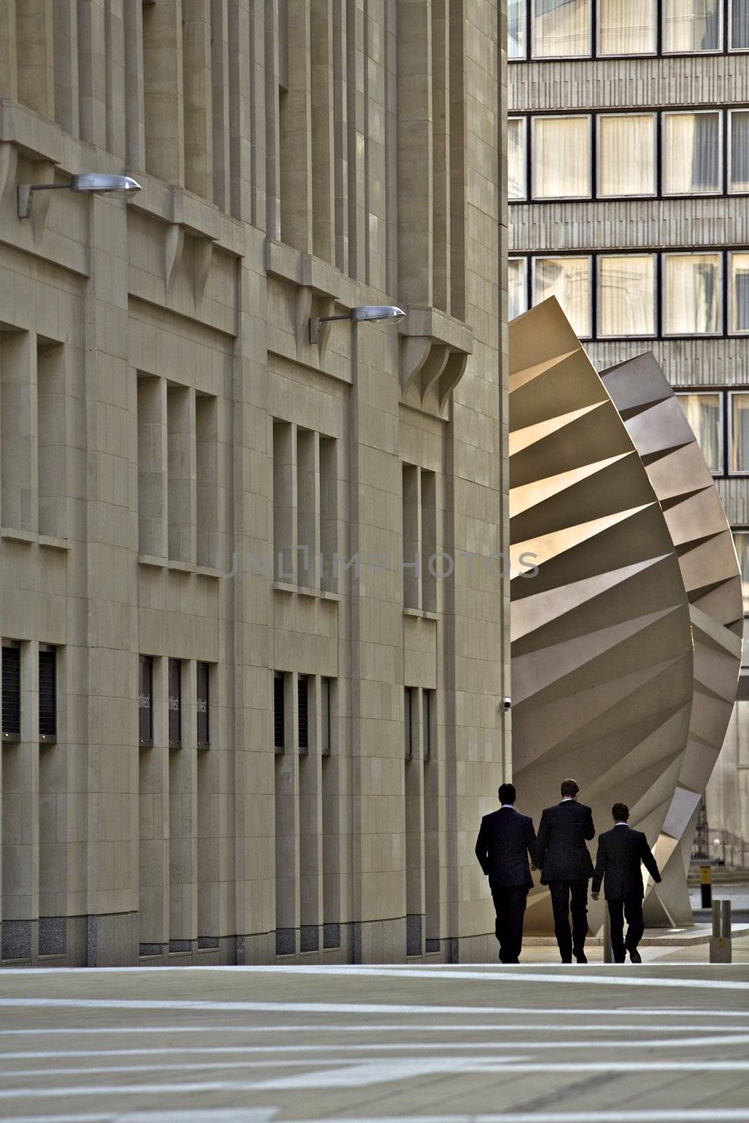 Corporate area with London architecture with three men walking