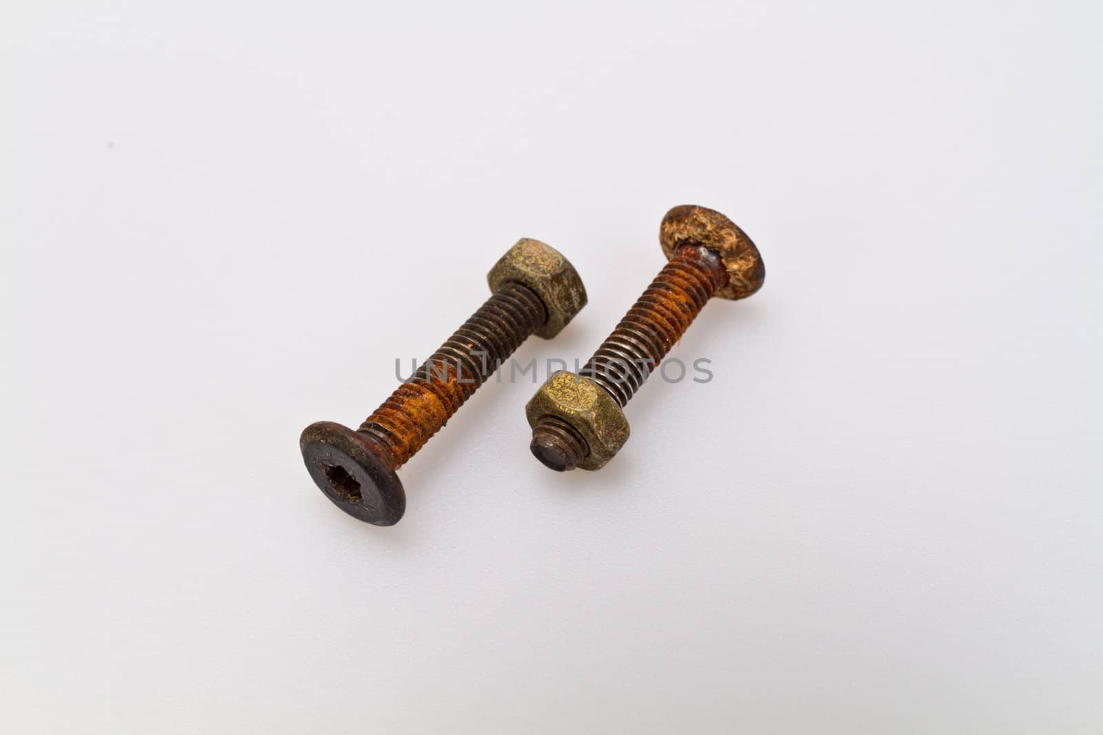 Old and rusty bolt and nut on white background
