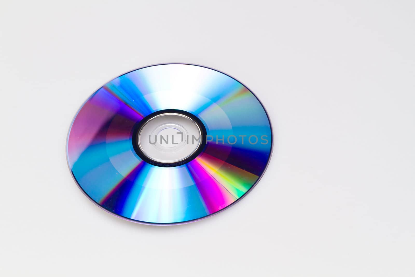Bland dvd on white background with its reflective blue surface upward