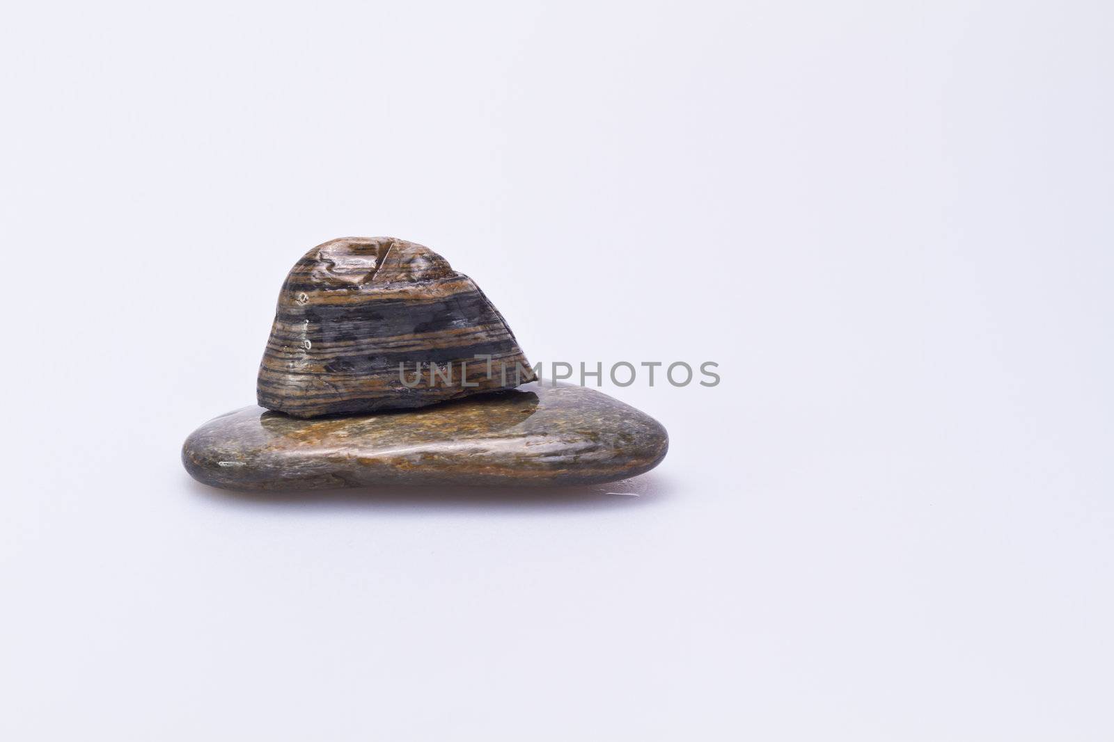 two stones stacking on each ther on white background in landscape orentation