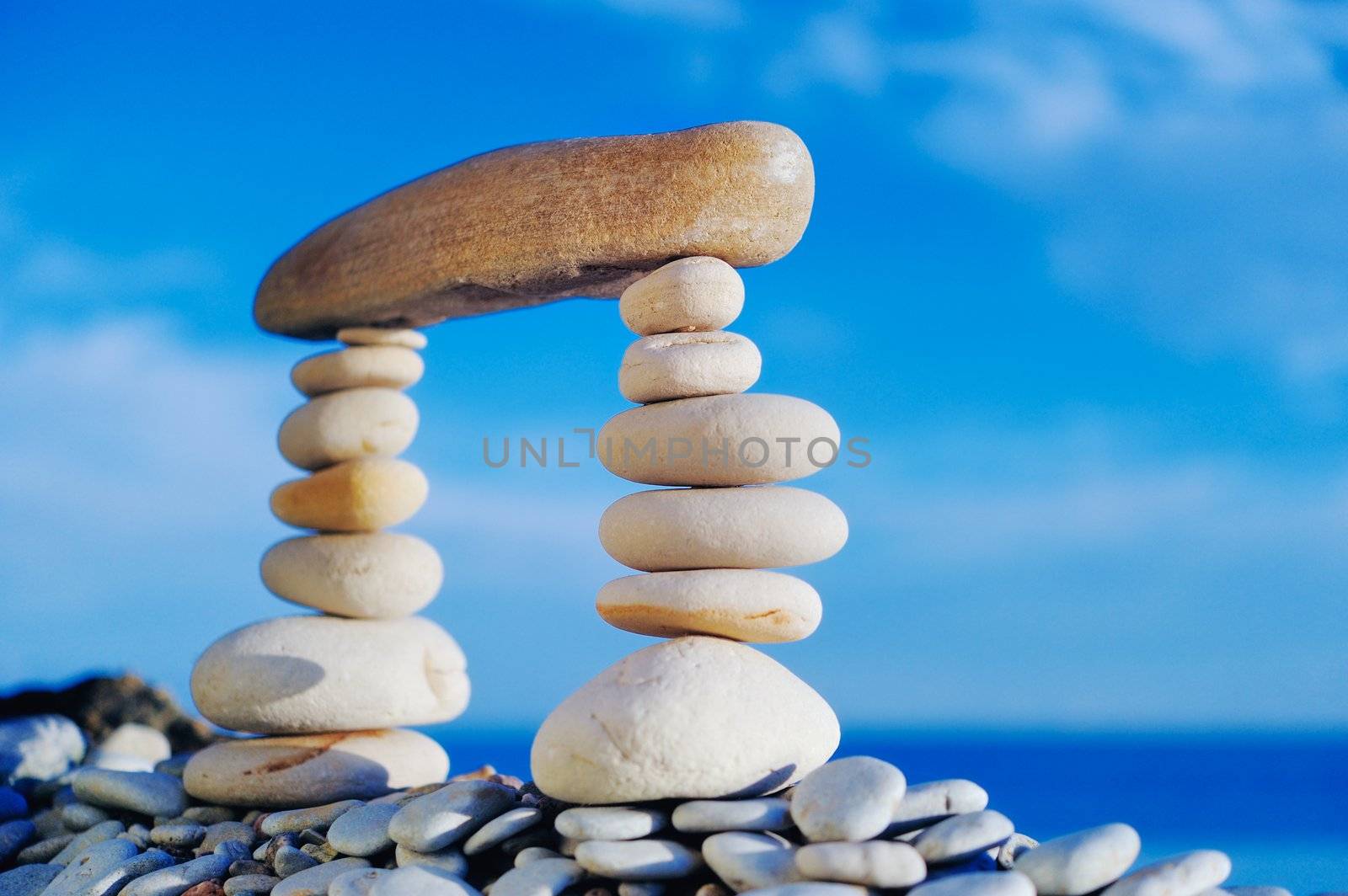 Long horizontal stone between a piles of pebble