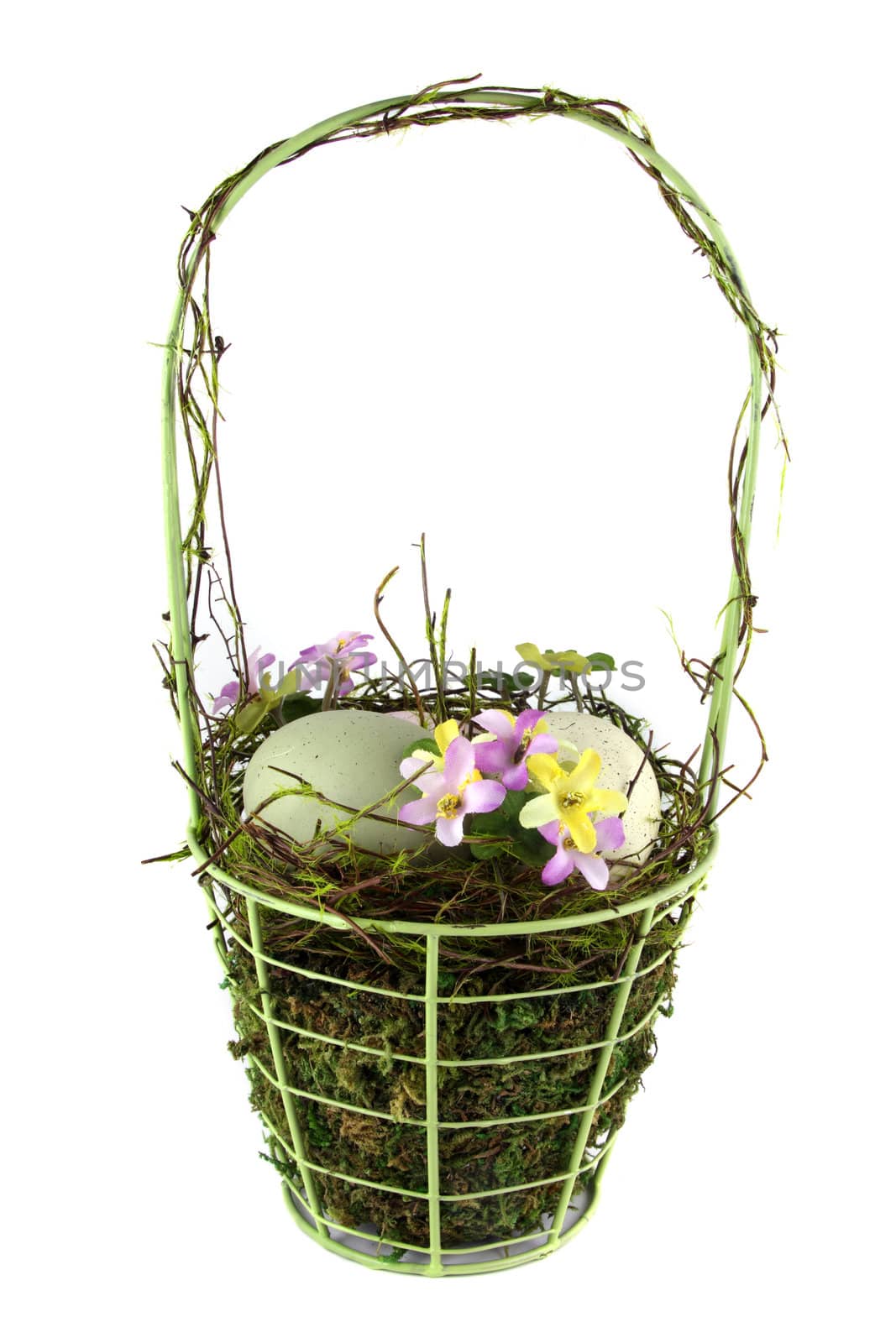 A decorative easter basket with easter eggs and flowers. Shot was taken on a solid white background.