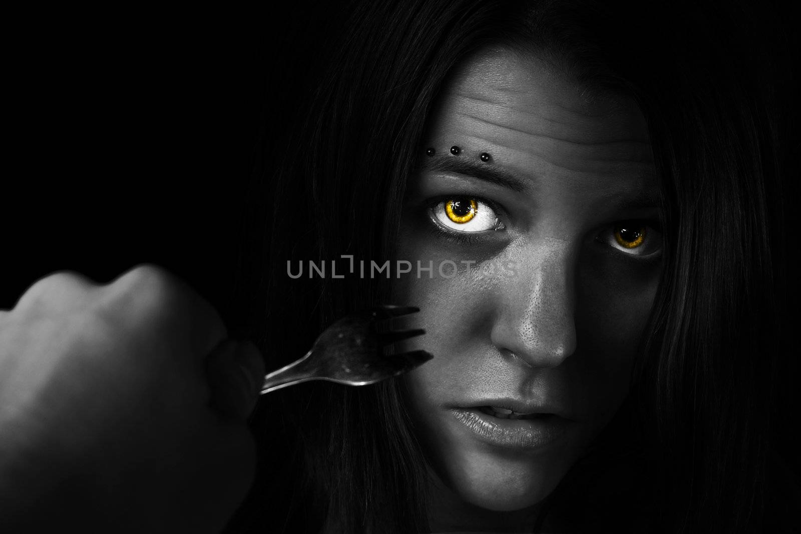 Picture of an intimidated girl. Eating disorders/fork.

Postprocessed with lightpainting in BW.