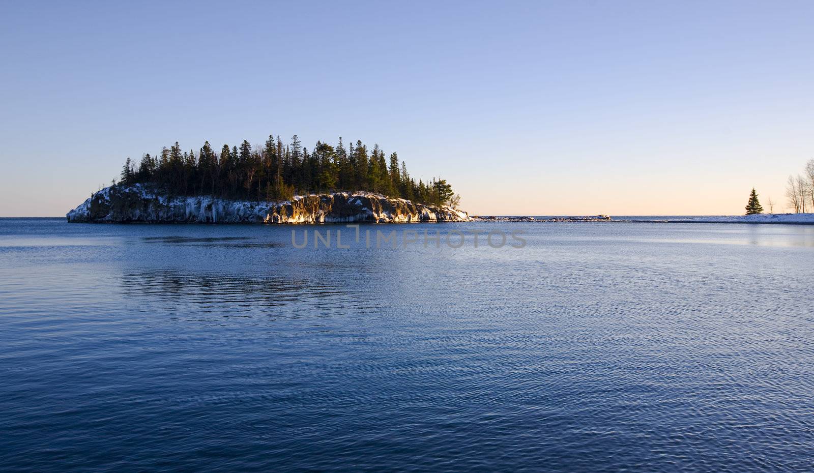 Island in the cold blue water of the north shore of Lake Superior in Minnesota