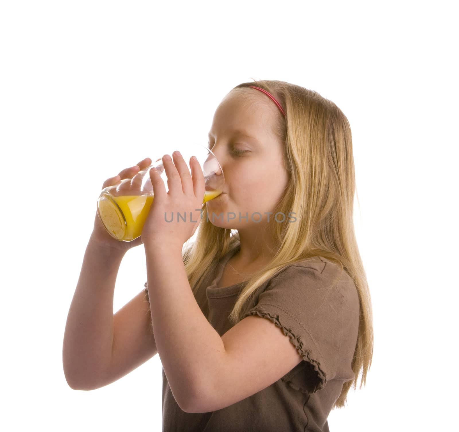 Thirsty girl drinking a glass of orange juice