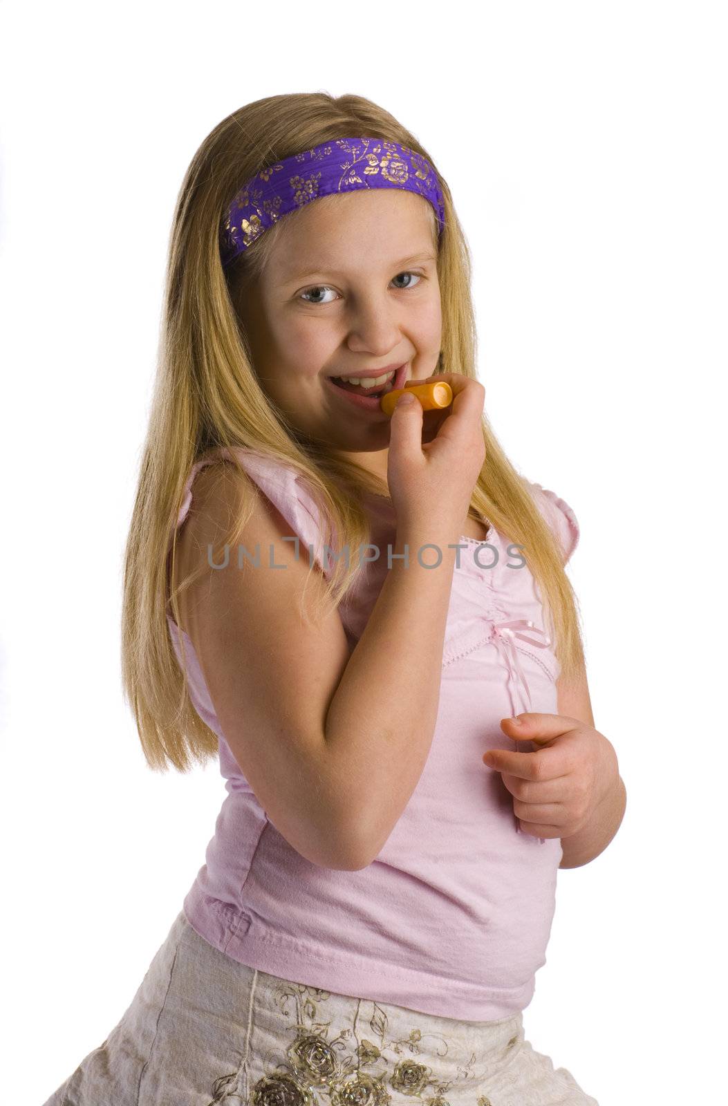 Girl applying lip balm salve to her chapped lips