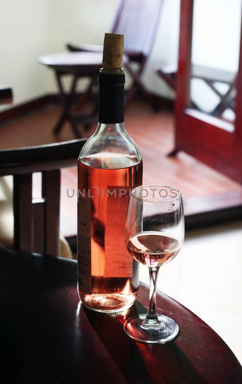 Bottle with the wine, the filled glass