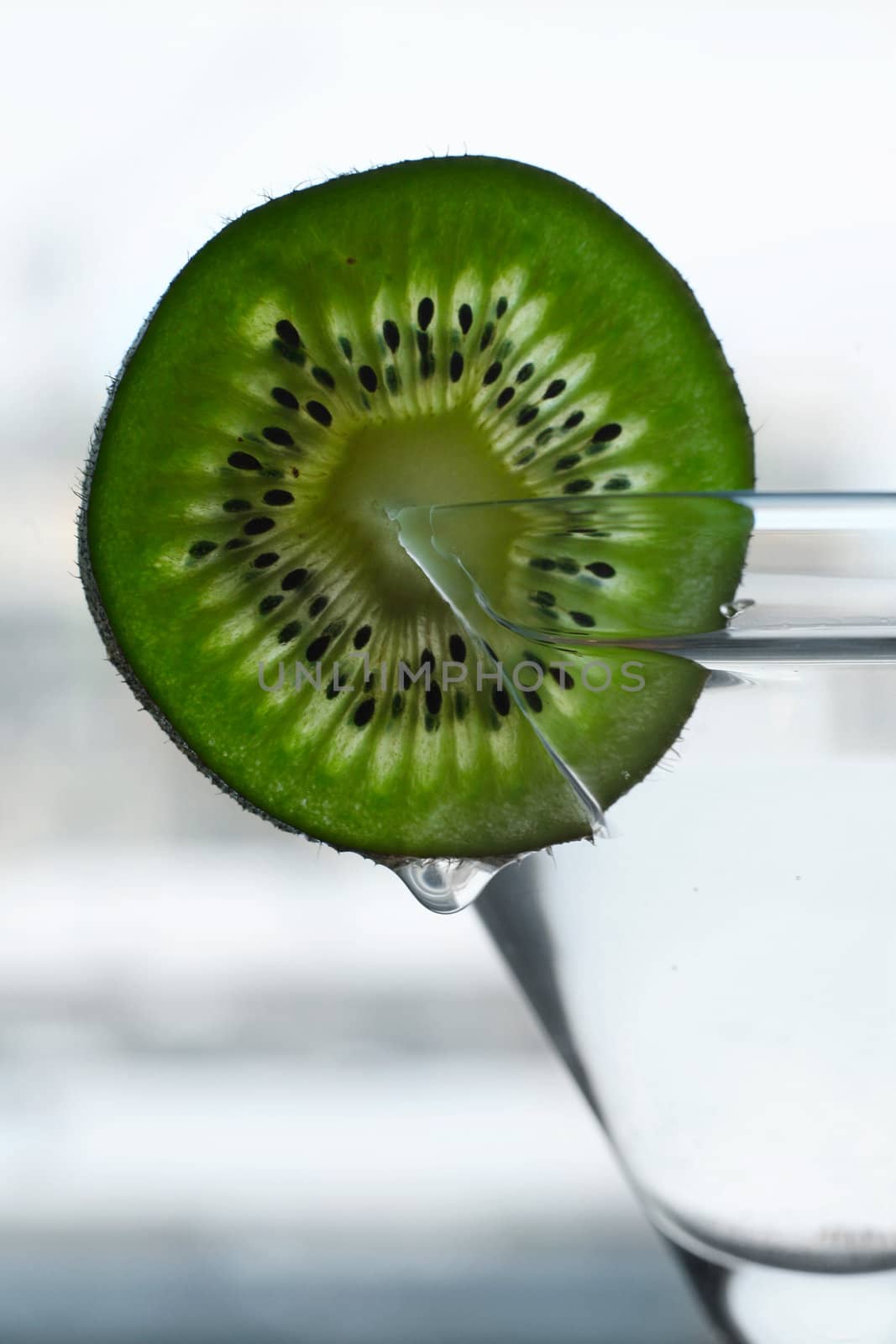 Glass with a plate kiwi on a dim background