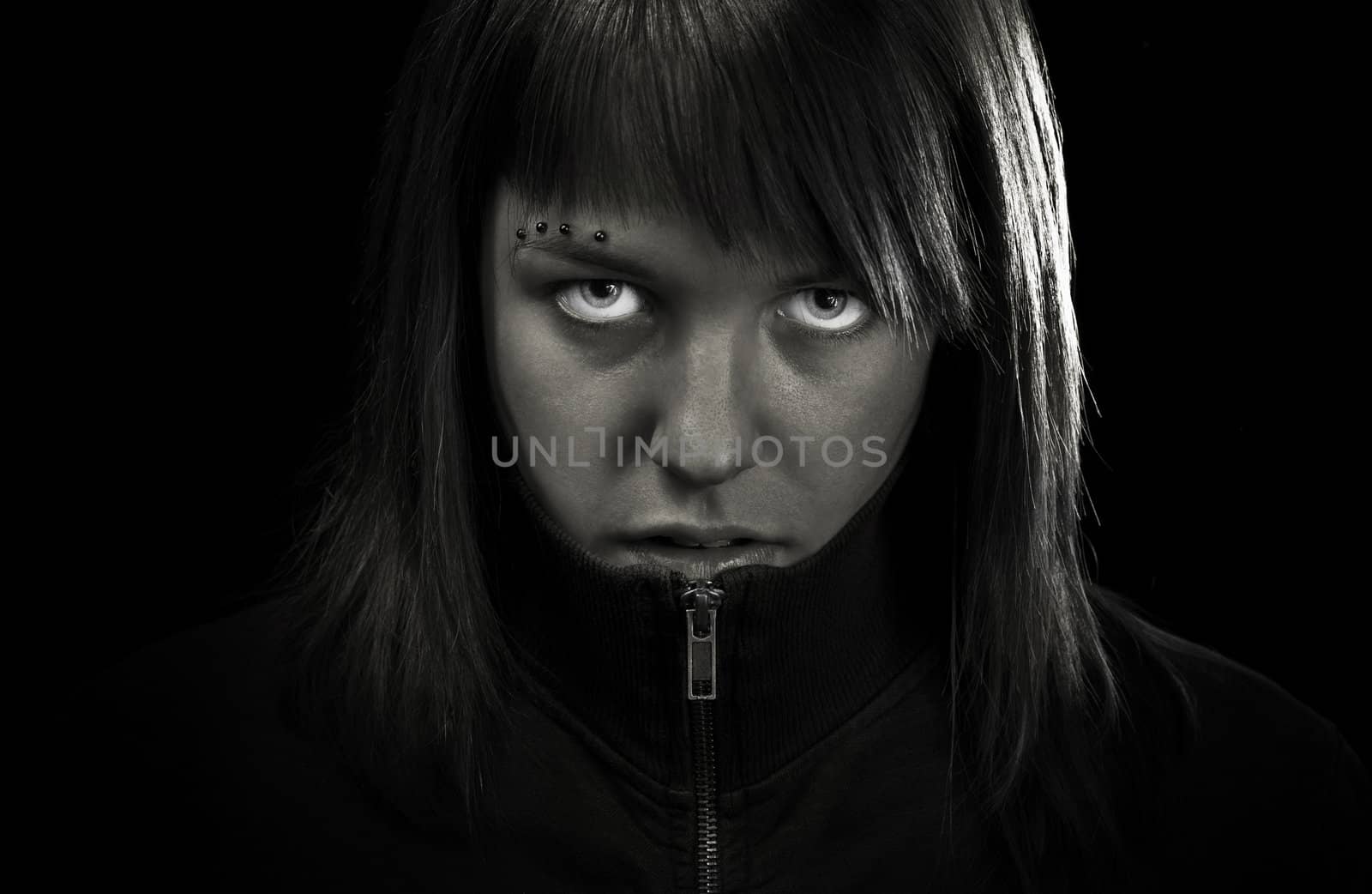 Angry girl looking straight to camera. Determined and confident.