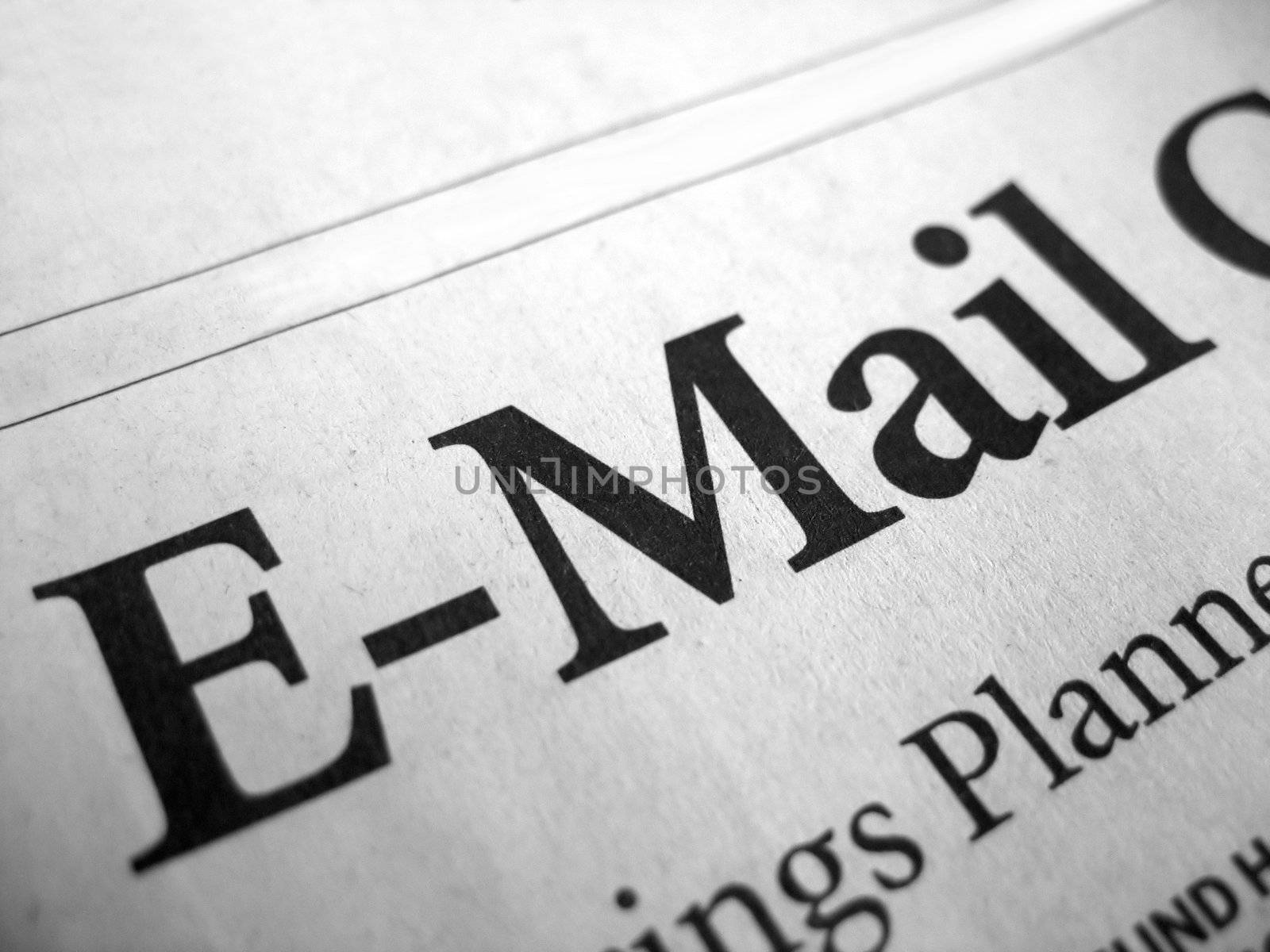 The word "e-mail" isolated from a newspaper headline.