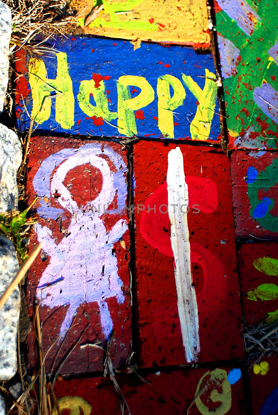 Happy child art, painted bricks