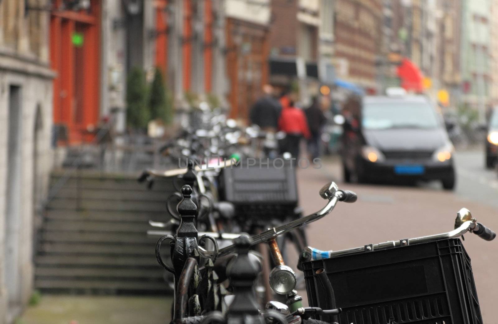 Image of crowded bicycles on a fence in a street of Amsterdam, Holland.