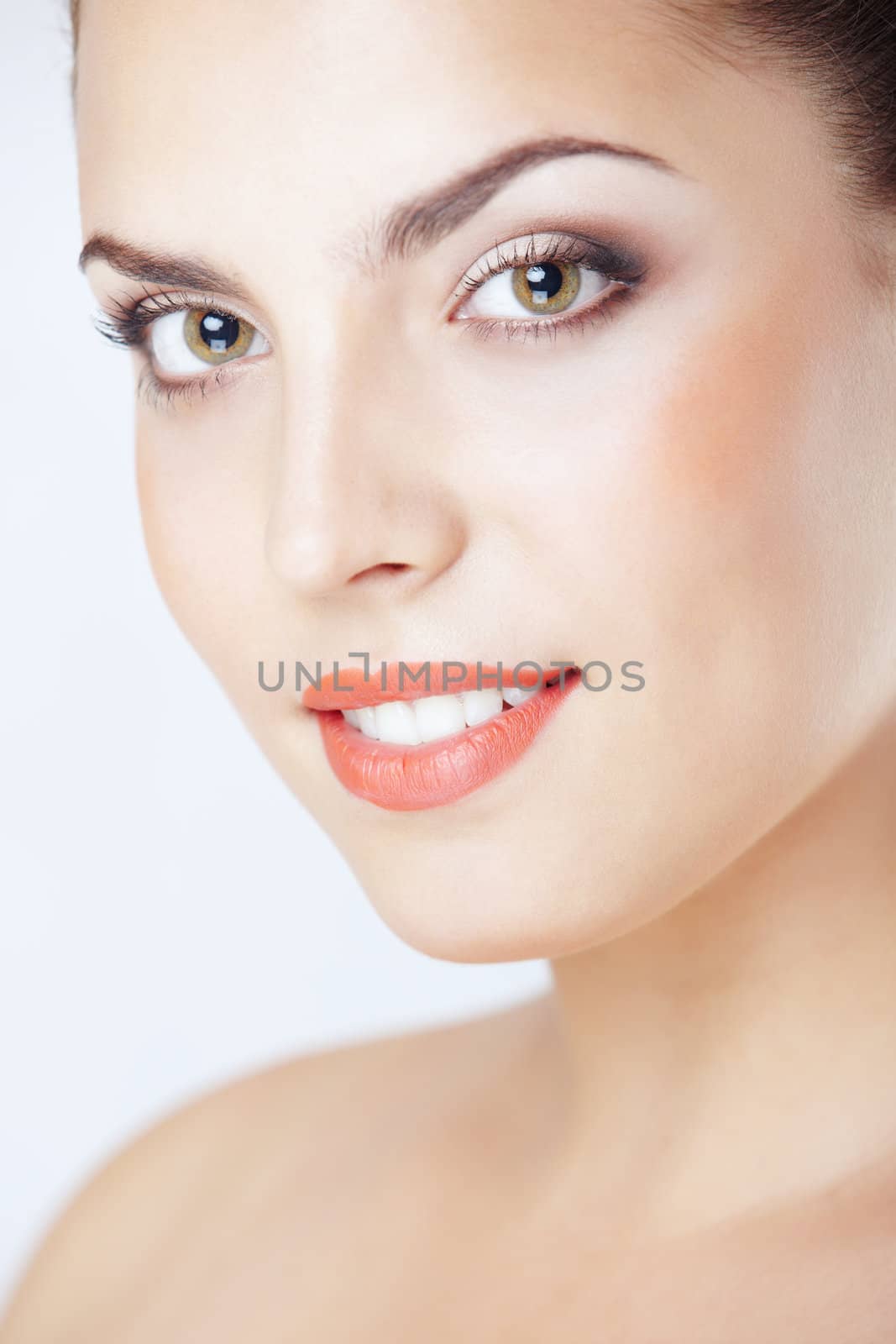 Beautiful lady with perfect makeup and good teeth on a studio background