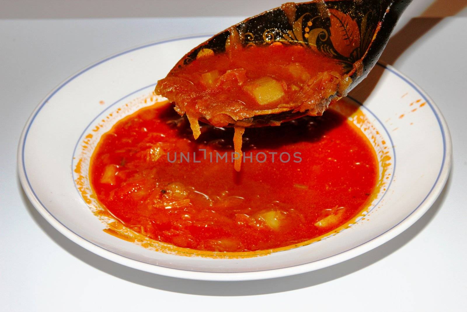 Borsch in a dish with a spoon. Red Russian soup.