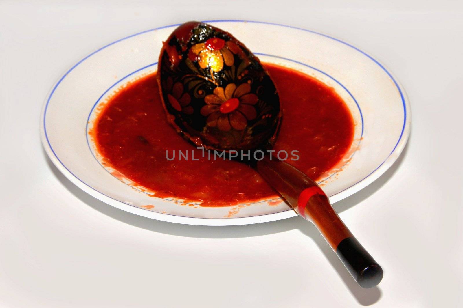 Borsch in a dish with a spoon. Red Russian soup.