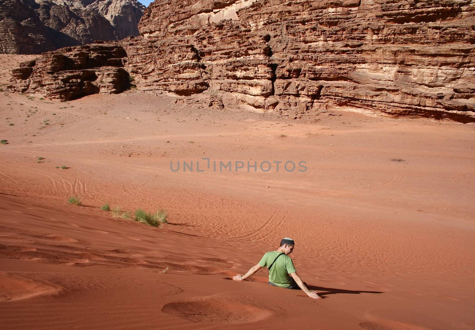 A western tourist is rolling over a sand dune in in Wadi Rum by nikolpetr