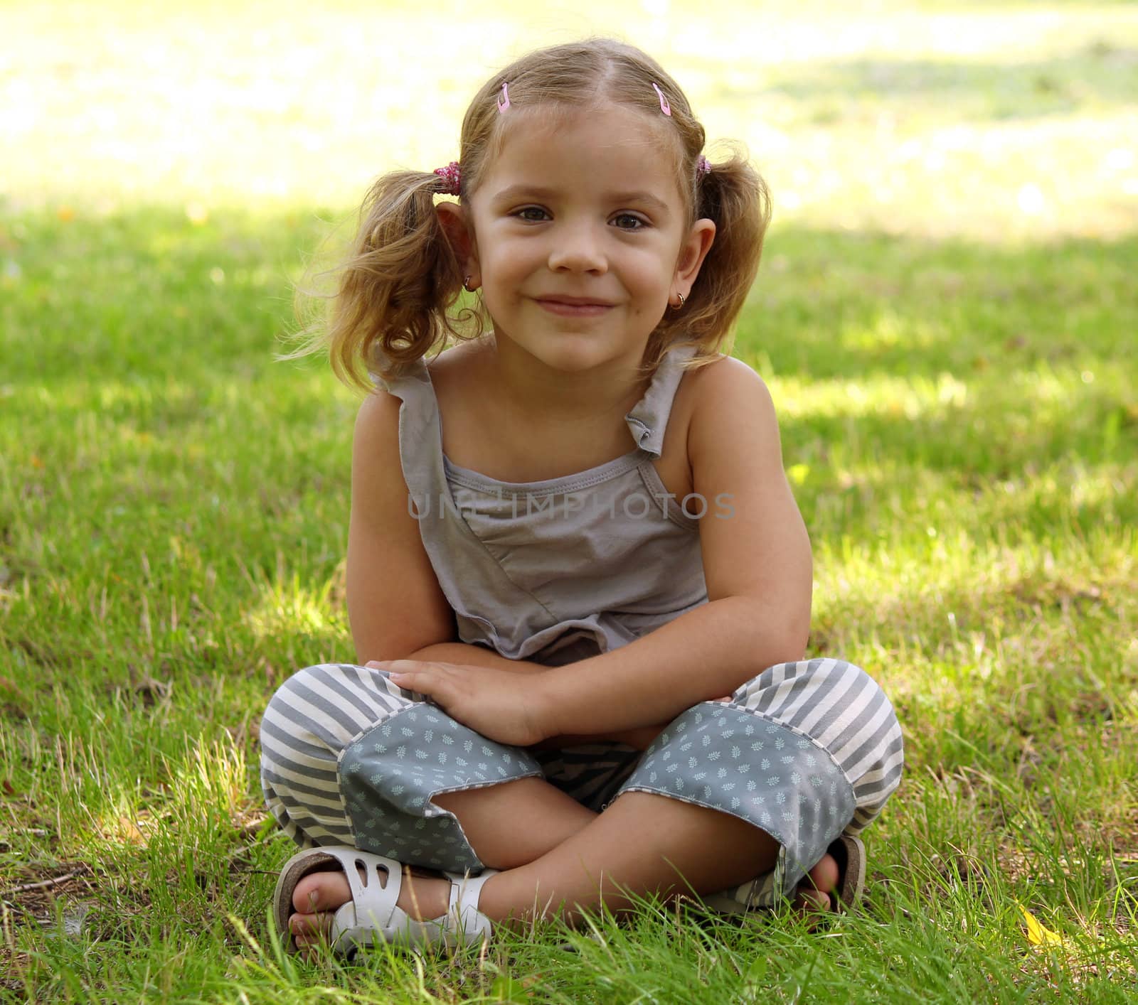 little girl sitting on grass