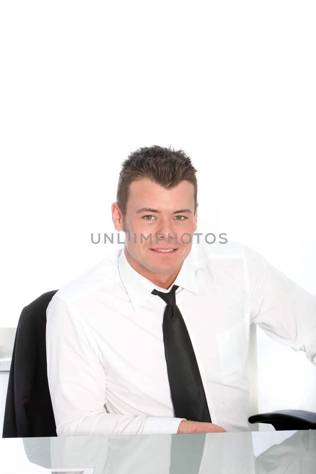 Handsome Businessman sitting isolated on a white background
