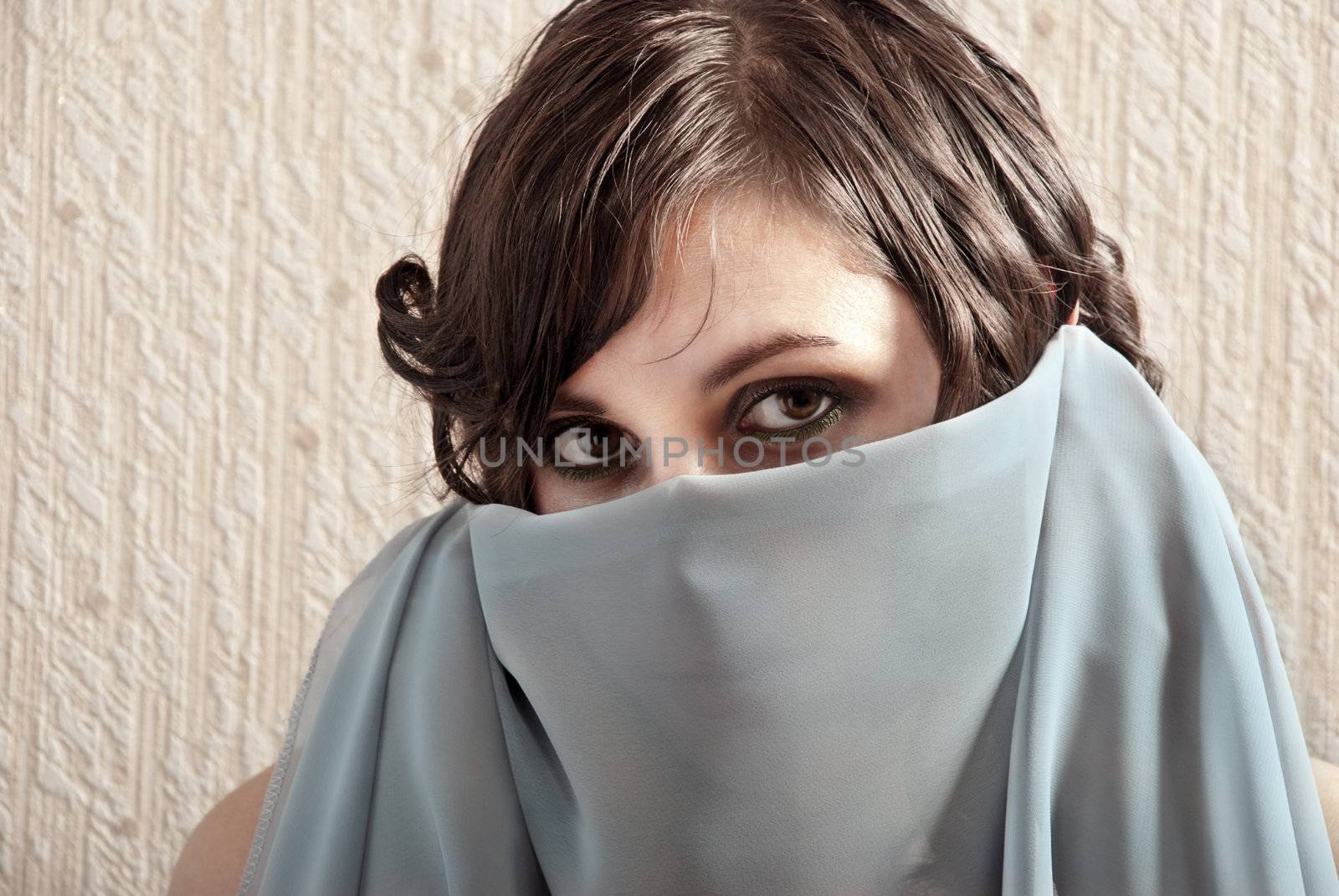 Beautiful portrait fashion woman with the face covered by the veil.