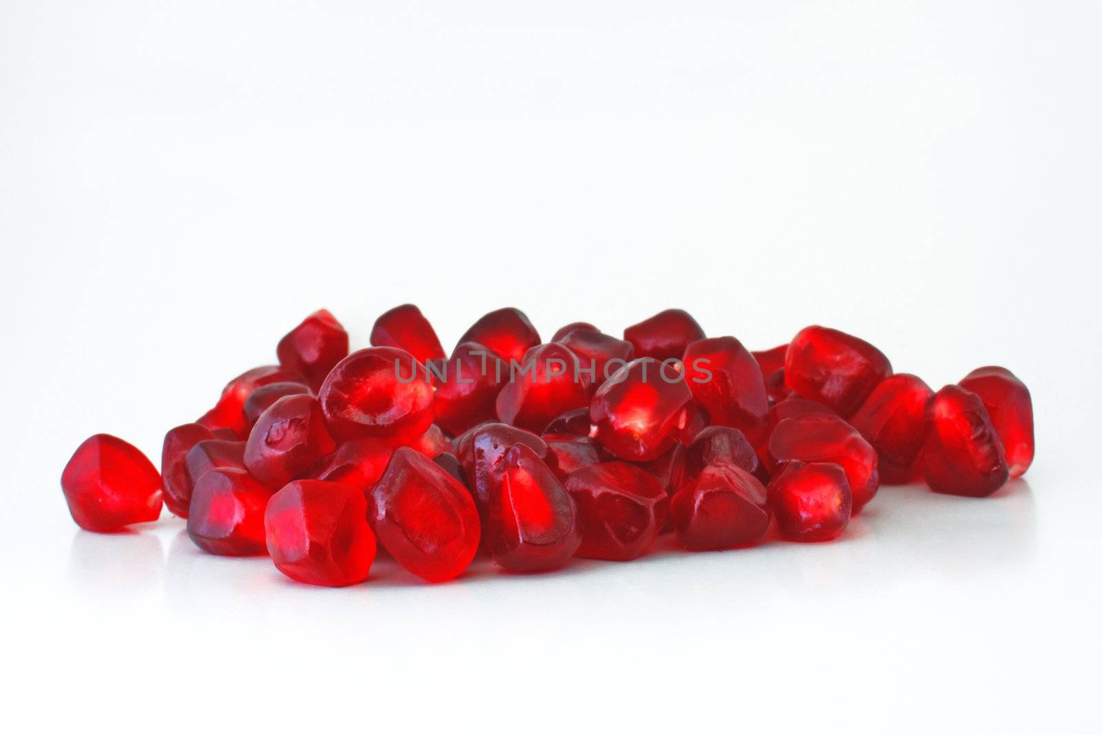 Pomegranate seeds, close-up, on a white background