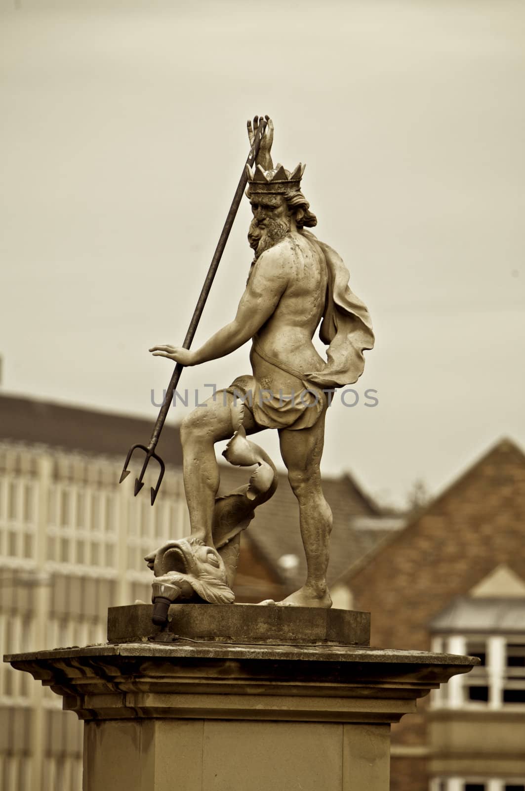 Statue of Zeus in marble and surrounded by buildings, sepia